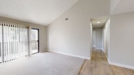 Located in Fountain Valley, CA, this single-floor, 3-bedroom, 1-bathroom home offers a well-organized layout designed for comfortable living. The living room is a standout space, featuring dramatic vaulted ceilings that amplify the sense of openness, neutral-toned walls, plush carpeting, and a sliding door that invites natural light from outside. A ceiling fan adds a practical touch to the area. The kitchen is thoughtfully updated with crisp white shaker cabinetry, granite-style countertops, stainless steel appliances including a refrigerator, gas range, and microwave, and light wood-look flooring that extends throughout the common areas. A skylight overhead brightens the space further. The hallway connects the living areas to three carpeted bedrooms, each featuring neutral walls, vertical blinds, and windows that bring in outdoor views and natural light. The primary bedroom offers a comfortable footprint suited for everyday use. The full bathroom is clean and modern, featuring a tub-shower combination, a white vanity with granite-style countertop, and wood-look flooring that ties the space together cohesively. The overall aesthetic is bright, neutral, and move-in ready.