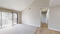 Located in Fountain Valley, CA, this single-floor, 3-bedroom, 1-bathroom home offers a well-organized layout designed for comfortable living. The living room is a standout space, featuring dramatic vaulted ceilings that amplify the sense of openness, neutral-toned walls, plush carpeting, and a sliding door that invites natural light from outside. A ceiling fan adds a practical touch to the area. The kitchen is thoughtfully updated with crisp white shaker cabinetry, granite-style countertops, stainless steel appliances including a refrigerator, gas range, and microwave, and light wood-look flooring that extends throughout the common areas. A skylight overhead brightens the space further. The hallway connects the living areas to three carpeted bedrooms, each featuring neutral walls, vertical blinds, and windows that bring in outdoor views and natural light. The primary bedroom offers a comfortable footprint suited for everyday use. The full bathroom is clean and modern, featuring a tub-shower combination, a white vanity with granite-style countertop, and wood-look flooring that ties the space together cohesively. The overall aesthetic is bright, neutral, and move-in ready.
