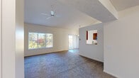 Located at 6057 Eighth Ave SW in Grandville, Michigan, this 2-bedroom, 2-bathroom home offers a well-designed single-level layout that balances comfort and functionality. The open living room is a standout feature, boasting vaulted ceilings, a ceiling fan, and large windows that flood the space with natural light and frame views of lush outdoor greenery. A sliding glass door leads to a private balcony, further enhancing the connection to the outdoors. Plush carpet runs throughout the living areas and bedrooms, adding warmth underfoot.

The kitchen is efficiently laid out with warm wood cabinetry, stainless steel appliances including a range, microwave, and refrigerator, and durable wood-look flooring. A pass-through window connects the kitchen to the living area, promoting an open and social atmosphere.

The spacious primary bedroom features vaulted ceilings and a large window with outdoor views, creating a bright and airy retreat. The second bedroom is equally well-lit with its own window and carpeted flooring. Both bathrooms are finished with wood-look flooring, warm wood vanities, and clean white fixtures — one featuring a full tub/shower combo. A dedicated closet rounds out the practical storage offerings throughout this inviting home.