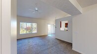 Located at 6057 Eighth Ave SW in Grandville, Michigan, this 2-bedroom, 2-bathroom home offers a well-designed single-level layout that balances comfort and functionality. The open living room is a standout feature, boasting vaulted ceilings, a ceiling fan, and large windows that flood the space with natural light and frame views of lush outdoor greenery. A sliding glass door leads to a private balcony, further enhancing the connection to the outdoors. Plush carpet runs throughout the living areas and bedrooms, adding warmth underfoot.

The kitchen is efficiently laid out with warm wood cabinetry, stainless steel appliances including a range, microwave, and refrigerator, and durable wood-look flooring. A pass-through window connects the kitchen to the living area, promoting an open and social atmosphere.

The spacious primary bedroom features vaulted ceilings and a large window with outdoor views, creating a bright and airy retreat. The second bedroom is equally well-lit with its own window and carpeted flooring. Both bathrooms are finished with wood-look flooring, warm wood vanities, and clean white fixtures — one featuring a full tub/shower combo. A dedicated closet rounds out the practical storage offerings throughout this inviting home.