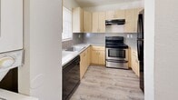 Located at 5955 Ceylon Ct in West Palm Beach, FL, this single-floor residence offers three bedrooms and two bathrooms within a well-organized layout. Light-toned laminate flooring runs throughout the home, lending a clean and cohesive aesthetic to every room.

The kitchen is efficiently designed with light maple cabinetry, a speckled tile backsplash, ample counter space, and a full suite of black appliances including a stainless electric range, dishwasher, and refrigerator. A window above the sink allows natural light to brighten the workspace.

The living room is open and airy, with neutral white walls and a sliding glass door that leads to a private balcony, inviting natural light and outdoor views into the space. The bedrooms are comfortably sized, each featuring neutral tones, laminate flooring, and windows with blinds that frame views of the surrounding greenery. Closet space is provided in the bedrooms, with sliding panel doors offering practical storage.

Both bathrooms are clean and functional, each featuring a full tub-shower combination. The overall ambiance of the home is bright and move-in ready, with a simple, understated palette that offers a versatile canvas for personalization.