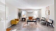 Located at 1840 Killingsworth Rd in Augusta, Georgia, this one-bedroom, two-bathroom unit offers a well-organized, single-floor layout designed for functional everyday living. The living room serves as the welcoming heart of the home, featuring wood-look flooring, neutral gray walls, and multiple windows that invite generous natural light throughout the day. The open kitchen and living area flow seamlessly together, with the kitchen showcasing white cabinetry, dark countertops, a black range, and an overhead exhaust — a clean and practical setup for home cooking. The bedroom is a comfortably sized retreat, outfitted with a ceiling fan, a window with blinds and curtains for light control, and the same durable wood-look flooring found throughout the unit. A dedicated closet provides convenient storage. Two full bathrooms serve the unit — one featuring a tub/shower combo with a curtain rod and wood-look flooring, and the other offering a vanity with a dark countertop, a large mirror, and warm overhead lighting. Neutral tones and consistent finishes create a cohesive, move-in-ready aesthetic throughout the space, making it a practical and inviting home in Augusta.