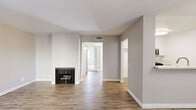 Located at 9933 Woodman Ave in Mission Hills, CA, this single-floor, 3-bedroom, 2-bathroom home offers a practical and well-appointed layout. The living room makes a welcoming first impression with its wood-look flooring, neutral gray walls, and a classic fireplace — an ideal focal point for the space. A hallway connects the living area to the rest of the home, maintaining a clean flow throughout.

The kitchen features white shaker cabinetry, light quartz countertops, a breakfast bar peninsula, and stainless steel appliances including a gas range and built-in microwave, all complemented by bright, even lighting.

The primary bedroom is a comfortable retreat, carpeted for warmth, with a mirrored sliding-door closet and a large window that invites natural light and outdoor views of surrounding greenery. The additional bedrooms are also carpeted and well-lit, each with windows framing pleasant exterior views.

Both bathrooms are clean and functional, featuring tub/shower combinations equipped with stainless steel grab bars for accessibility, set against crisp white surroundings with wood-look flooring.

Neutral tones, updated finishes, and consistent design elements throughout give this home a cohesive, move-in-ready feel.