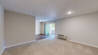 Located at 548 N Civic Dr in Walnut Creek, CA, this two-bedroom, one-bathroom residence offers a practical and comfortable layout across its well-organized floor plan. The living room is bright and open, featuring sliding glass doors that lead to a private outdoor deck framed by mature trees — a serene spot to enjoy the California surroundings. A wall-mounted PTAC unit provides climate control, and the transition from carpet to hardwood-style flooring defines the living space clearly.

The kitchen is thoughtfully updated with white shaker cabinetry, dark granite countertops, stainless steel appliances including a refrigerator, electric range, and microwave, and durable wood-look flooring. A peninsula counter adds functional prep and serving space.

Both bedrooms are carpeted and bathed in natural light from large windows. The primary bedroom offers a comfortable footprint with a window view of the lush outdoors, while the second bedroom includes a built-in closet with shelving. The shared full bathroom features a tub/shower combination, a granite-topped vanity, and wood-look flooring. A connecting hallway and dedicated closet complete the practical layout of this well-maintained Walnut Creek home.