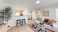 Located at 5707 SE 48th St in Oklahoma City, OK, this single-story 2-bedroom, 2-bathroom home offers a thoughtfully designed layout with a bright, cohesive aesthetic throughout. Light wood-style flooring runs through the main living areas, complementing the crisp white walls and creating a clean, welcoming atmosphere.

The open-concept living room connects seamlessly to the kitchen via a pass-through counter with bar seating — ideal for casual dining or entertaining. The living area features a textured ceiling, natural light from a large window, and direct access to the front entry. The galley-style kitchen is efficiently organized with warm wood cabinetry, granite-style countertops, a double-basin sink, a skylight, and white appliances including a range, dishwasher, and full-size refrigerator.

Both bathrooms mirror each other in style, each featuring warm wood vanity cabinetry, granite-style countertops, and a shower-tub combo with a curtain, set on light wood flooring. The bedrooms are comfortably sized, each with a ceiling fan, natural light from windows, and access to closet space — the primary bedroom includes a walk-in closet. A dedicated in-unit laundry area with shelving adds everyday convenience. Two hallways connect the layout efficiently, rounding out this functional and inviting home.