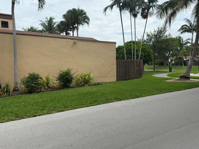 Private backyard lakefront has privacy with a wooden fence - 13169 SW 91st Ct