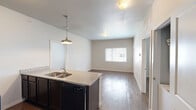 Located at 312 W Elm Ave in Stillwater, Oklahoma, this single-floor unit offers 2 bedrooms and 3 full bathrooms in a well-appointed, efficiently designed layout. Wood-style flooring flows throughout the space, complementing the neutral, light-toned walls that create a clean and cohesive aesthetic.

The kitchen serves as a functional centerpiece, featuring granite countertops, a large island with a double-basin stainless steel sink, dark espresso cabinetry, and black appliances including a refrigerator, electric range, and built-in microwave. Stylish pendant lighting over the island adds a modern touch.

Both bedrooms are comfortably sized, each featuring wood-style flooring, neutral walls, and windows that allow natural light to brighten the space. The primary bedroom includes a walk-in closet outfitted with wire shelving, offering practical storage solutions.

All three bathrooms are full baths, each equipped with a tub/shower combo, toilet, and a vanity topped with granite countertops and dark cabinetry. The consistent use of quality finishes across each bathroom reinforces the cohesive design language found throughout the unit.

Overall, this residence presents a practical and modern living environment with consistent finishes, ample storage, and a straightforward layout ideal for everyday comfort.