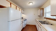 Located at 150 Reed Way in Sunbury, Ohio, this two-floor residence offers a practical and well-organized layout with a clean, neutral aesthetic throughout. The galley-style kitchen is efficiently designed, featuring white cabinetry with warm wood accents, a gas range, refrigerator, dishwasher, and a stainless steel sink. Durable hardwood-style flooring runs through the kitchen, providing easy maintenance and a warm visual contrast to the light-colored walls and textured ceilings.

The living area is spacious and carpeted, with neutral tones and an open feel that connects naturally to the rest of the home. Multiple bedrooms are found across the two floors, each featuring plush carpet, windows with blinds that allow natural light, and textured ceilings. One bedroom includes a dedicated closet, adding practical storage.

The home includes multiple bathrooms. One full bathroom features a vanity with wood cabinetry, granite-style countertops, a mirror with overhead lighting, and a tub/shower combination with hardwood-style flooring. A secondary half-bath provides a single vanity, toilet, and hardwood-style flooring. A third bathroom offers a clean, bright full suite with a tub/shower, single vanity, and matching hardwood-style floors. Throughout, the space maintains a consistent, functional design suited for comfortable everyday living.