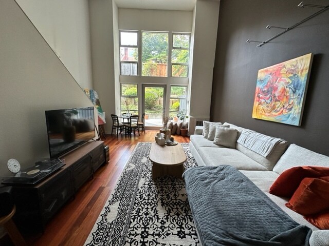 Living room with walls of windows which lead to patio - 1970 Sutter St #113