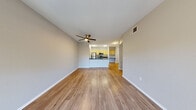 Located at 3055 Floyd Ave in Modesto, California, this well-appointed one-bedroom, one-bathroom residence offers a thoughtfully designed single-floor layout. The open-concept living and kitchen area serves as the heart of the home, featuring durable hardwood-style flooring, neutral-toned walls, and a ceiling fan that enhances the bright, airy atmosphere. Sliding glass doors lead to a private balcony, bringing in natural light and views of lush surrounding greenery.

The kitchen is a functional standout, equipped with a full suite of stainless steel appliances — including a gas range, microwave, and refrigerator — complemented by light wood cabinetry and sleek dark countertops. A peninsula with bar-top seating provides additional workspace and a natural divide between the kitchen and living area.

The bedroom is carpeted for comfort and features a large window that frames outdoor tree views, filling the space with natural light. A dedicated closet offers convenient storage. The bathroom is finished with hardwood-style flooring, a vanity with dark countertops and light wood cabinetry, and a full tub-shower combination. Additional conveniences include an in-unit laundry area, a hallway, and ample closet storage, making this a complete and practical living space.