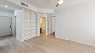 Located at 101 Cimarron Trl in Irving, TX, this two-story, 2-bedroom, 1-bathroom home offers a well-organized layout across two levels. The main living area features light wood-look flooring throughout, a bright open-concept design, and a tiled fireplace that serves as a focal point in the living room. The kitchen is outfitted with stainless steel appliances including an electric range and over-the-range microwave, bold navy-blue cabinetry, white countertops, and a subway tile backsplash. A convenient in-unit laundry area with a full-size washer and dryer is tucked nearby. The bathroom features light wood-look flooring, a full tub-shower combo, and a navy vanity that ties in with the kitchen's color scheme. Both bedrooms are carpeted and feature ceiling fans; the primary bedroom includes built-in shelving and direct access to the bathroom, while the second bedroom offers two windows that bring in natural light. A dedicated closet provides additional storage. The attached garage is equipped with an automatic opener and offers ample space. Crown molding and textured ceilings add character throughout, creating a cohesive and functional living environment.