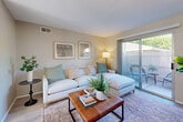 Located at 721 Gardenia Cir in Paso Robles, CA, this single-story 2-bedroom, 1-bathroom home offers a well-designed layout with a clean, contemporary aesthetic. Light wood-look flooring runs throughout, complementing the warm neutral tones found in every room.

The living room is a welcoming space featuring sliding glass doors that open to a private outdoor patio, allowing natural light to pour in and creating a seamless indoor-outdoor connection. The adjoining dining area provides a dedicated space for meals and flows directly into the kitchen, which features white shaker cabinetry extending to the ceiling for ample storage, white quartz countertops, and a full suite of white appliances. A second door in the kitchen/dining area provides additional outdoor access.

The spacious primary bedroom includes a ceiling fan, generous closet space, and a window with natural light. The second bedroom is similarly well-appointed with a ceiling fan and closet. The shared bathroom is clean and bright, finished with light wood-look flooring, a white vanity, and a tub/shower combination illuminated by a frosted window.

Throughout the home, neutral wall tones, consistent flooring, and thoughtful design choices create a cohesive, move-in-ready atmosphere ideal for comfortable everyday living.