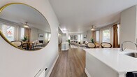 Located at 2750 W Wigwam Ave in Las Vegas, Nevada, this well-appointed 1-bedroom, 2-bathroom residence offers a comfortable and modern living experience across a single floor. The open-concept layout connects the kitchen and living room seamlessly, creating a bright and airy atmosphere enhanced by natural light streaming through multiple windows. Warm hardwood-style flooring runs throughout the main living areas, adding a cohesive and polished look.

The kitchen is thoughtfully designed with white shaker cabinetry, quartz countertops, a peninsula with bar seating, and a full suite of stainless steel appliances including a gas range, microwave, dishwasher, and refrigerator. The adjacent living room is generously proportioned, featuring a fireplace and ample wall space, while a ceiling fan adds comfort to the dining area nearby.

The bedroom offers a tranquil retreat with a bay-style window configuration that fills the room with natural light and two closets for generous storage. Both bathrooms are clean and contemporary, each featuring white vanities with quartz countertops and large mirrors. One bathroom includes a shower-tub combination with tiled surround. The neutral color palette throughout lends the space a calm, modern ambiance well-suited to a variety of lifestyles.