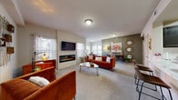 Located on Mezzaluna Ave in Oklahoma City, OK, this single-story residence offers a thoughtfully designed layout with 1 bedroom, 2 bathrooms, a kitchen, dining area, closet, and hallway. The open-concept living and dining area is a standout feature, highlighted by plush carpeting, abundant natural light from multiple windows with stylish blinds and curtains, and a sleek wall-mounted electric fireplace beneath a flat-screen TV. The dining nook benefits from corner windows that brighten the space.

The kitchen is well-equipped with dark cabinetry, stainless steel appliances including a French door refrigerator and microwave, a subway tile backsplash, and a generous island with striking marble-style countertops — ideal for both cooking and casual entertaining. Wood-look tile flooring runs throughout the kitchen and bathrooms, adding a cohesive, modern touch.

The primary bedroom is generously sized, featuring a ceiling fan, carpet flooring, and ample natural light. The bathroom includes a tub-shower combo with white tile surround, dark vanity cabinetry, and marble-style countertops. A dedicated utility area with washer/dryer hookups adds everyday convenience. Overall, the space presents a warm, contemporary ambiance suited for comfortable living.