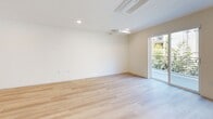 Located at 14629 Erwin St in Van Nuys, Los Angeles, this thoughtfully designed single-story home offers three bedrooms and three bathrooms across a well-proportioned floor plan. Light-toned hardwood flooring runs throughout, lending a clean, cohesive feel to every room.

The open kitchen and living area serves as the heart of the home, where a modern kitchen stands out with sleek white flat-front cabinetry, a striking amber-orange tile backsplash, dark grey countertops, a central island with additional prep space, and stainless steel appliances. The adjacent living area features a ceiling-mounted HVAC unit and expansive sliding glass doors that flood the space with natural light and provide direct access to a balcony with greenery views.

The primary bedroom is generously sized and includes mirrored sliding closet doors, a ceiling-mounted mini-split system, and recessed lighting. The additional bedrooms are bright and airy, each with recessed lighting, light wood flooring, and windows that bring in natural light. One bedroom features a dedicated closet space.

The three bathrooms maintain the home's clean modern aesthetic, with white subway tile surrounds in the tub/shower combinations, undermount sinks set into grey countertops, and white cabinetry. A dedicated hallway connects all rooms, completing this well-organized and contemporary Los Angeles home.