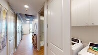 This 1-bedroom, 1-bathroom residence in Baton Rouge, Louisiana, blends industrial-chic architecture with contemporary finishes throughout. The open living area makes a strong first impression with soaring ceilings that showcase exposed concrete beams and visible ductwork, complemented by warm hardwood flooring. Large windows invite natural light, while a ceiling fan adds both function and style to the space.

The kitchen is well-appointed with light gray shaker-style cabinetry, stainless steel appliances including a gas range and refrigerator, a white tile backsplash, and clean white countertops. Pendant lighting overhead adds a modern touch, and an adjacent dining nook provides a convenient space for everyday meals.

The bedroom offers a calm, comfortable retreat with neutral tones, hardwood flooring, and exposed beam accents that carry the industrial aesthetic throughout. The full bathroom features large-format marble-look tile flooring, a glass-enclosed shower, a dual-sink vanity with backlit mirror, and direct access to a dedicated closet with built-in cabinetry for ample storage.

A private balcony, accessible from the unit, provides sweeping elevated views of downtown Baton Rouge and the surrounding cityscape, making it an ideal spot for taking in the urban landscape.