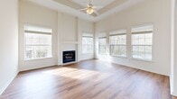 Located at 150 Du Rhu Dr in Mobile, Alabama, this two-story home offers 3 bedrooms, 3 bathrooms, and a thoughtfully designed layout across its two levels. The main living level hosts the primary living spaces, including a bright living room with hardwood floors and large windows that flood the room with natural light and provide views of the surrounding neighborhood. The kitchen is well-appointed with white cabinetry, a center island, pendant lighting, tile flooring, and elegant arched doorways that add architectural character throughout. A dedicated dining room and laundry room complete the main floor's functionality. The bedrooms feature a mix of plush carpeting and hardwood floors, with ceiling fans and ample natural light from large windows. The generously sized primary bedroom includes a private en-suite bathroom with a dual-sink vanity, a separate glass-enclosed shower, and a soaking tub. Additional closets provide plentiful storage throughout. The home also includes an attached garage with an automatic opener. A dedicated laundry room features wire shelving and utility connections. The overall aesthetic is clean and neutral, with white walls, crown molding accents, and consistent finishes that create a bright, cohesive ambiance throughout the home.