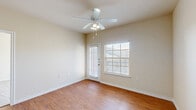 Located at 4460 Ashberry St in Fort Worth, Texas, this single-story 2-bedroom, 2-bathroom home offers a well-organized layout designed for comfortable everyday living. The interior is finished with warm wood-look hard flooring throughout the main living areas and hallways, complemented by neutral, light-toned walls that create a bright and cohesive atmosphere.

The open living and dining area serves as the heart of the home, featuring a ceiling fan with light fixture and a glazed door alongside a large window that invites generous natural light and outdoor views. The kitchen is efficiently designed with honey-toned cabinetry, laminate countertops, a double stainless steel sink, and black appliances including a range, over-the-range microwave, and refrigerator.

A dedicated hallway connects the main living spaces to the private areas of the home. Both bedrooms are carpeted for comfort and include ceiling fans and closets with built-in rods. The primary bedroom is notably spacious, with a large window that floods the room with natural light. Each bathroom is equipped with a shower/tub combination, vanity with cabinet storage, and wood-look flooring. A separate laundry area with washer and dryer hookups and a water heater rounds out the practical features of this well-appointed home.
