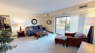 Located at 8110 Deepwood Blvd in Mentor, Ohio, this well-appointed one-bedroom, one-bathroom residence offers a thoughtfully organized single-floor layout. The living room serves as the heart of the home, featuring soft carpeting, neutral walls, and a large sliding glass door that floods the space with natural light while providing pleasant views of the surrounding greenery. The open flow connects the living area to a dedicated dining space, complete with chandelier lighting and ample room for a full dining set. The galley-style kitchen is efficiently designed with light cabinetry lining both sides, white countertops, tile flooring, and a pantry closet for additional storage. The generously sized primary bedroom offers carpeted floors, a textured ceiling, a large window for natural light, and a closet with bifold doors. The bathroom features a vanity with ample counter space, white cabinetry, tile flooring, and overhead lighting. A hallway connects the main areas of the home, contributing to a logical and comfortable flow throughout. With a clean, neutral palette and functional layout, this residence provides a practical and inviting living environment in the Mentor, Ohio community.