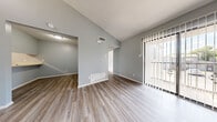Located at 3410 Wildewood Dr in San Angelo, Texas, this single-floor, 2-bedroom, 2-bathroom residence offers a clean, neutral aesthetic throughout. The interior is finished with light luxury vinyl plank flooring in the main living areas, hallways, kitchen, and bathrooms, while plush carpet adds warmth to both bedrooms.

The living room is a standout space, featuring vaulted ceilings that enhance the sense of openness and a full-length sliding glass door with vertical blinds that floods the room with natural light and provides direct outdoor access. A second adjacent area offers additional flexible living space.

The galley-style kitchen is efficiently laid out with brown cabinetry lining both walls, light countertops, a dishwasher, and a range, providing ample storage and functionality.

The spacious primary bedroom benefits from vaulted ceilings, multiple windows for natural light, and a generous walk-in closet with dual hanging rods. The second bedroom also features a window with exterior views. Both bathrooms are finished with wood-look LVP flooring; the primary bath includes a vanity with integrated sink and a tiled soaking tub.

Two hallways connect the spaces seamlessly, contributing to the unit's well-organized, flowing layout.