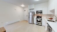 Located at 2024 Durant Ave in Berkeley, CA, this 2-bedroom, 2-bathroom residence offers a clean, modern design across a single floor. The open-concept living, dining, and kitchen area forms the heart of the space, finished with light wood flooring and a neutral white palette that creates a bright, airy atmosphere. The kitchen is well-appointed with stainless steel appliances — including a refrigerator, range, microwave, and dishwasher — paired with ample white cabinetry and light countertops. Natural light filters in through windows fitted with blinds, complementing the flush ceiling lighting throughout. Both bedrooms are comfortably sized, with the primary bedroom offering a ceiling fan and window with natural light. The second bedroom is a cozy, efficiently designed space. Each bathroom features a full tub-shower combination with white tile surround, light wood-tone flooring, and chrome fixtures. A dedicated in-unit laundry area adds everyday convenience, while a hallway and closet provide practical storage solutions. The overall design aesthetic is modern and minimalist, offering a clean, functional living environment well-suited to Berkeley's urban setting.