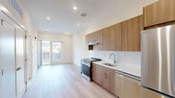 Located at 130 W Girard Ave in Philadelphia's vibrant 19123 zip code, this modern 1-bedroom, 1-bathroom unit offers a thoughtfully designed open-concept layout finished with light hardwood flooring and recessed lighting throughout. The kitchen is a standout feature, showcasing warm wood cabinetry extending to the ceiling, a white subway tile backsplash, clean white countertops, and a full suite of stainless steel appliances including a gas range and refrigerator. The kitchen flows seamlessly into the living area, which is bathed in natural light from glass double doors that open onto a private balcony with views of the surrounding Philadelphia streetscape. The bedroom is a bright, clean space with a large window overlooking the neighborhood, complemented by light hardwood floors and a recessed ceiling light. The bathroom features light tile flooring and a clean, minimalist design. Additional conveniences include two closets and a dedicated laundry area within the unit. The overall aesthetic is modern and neutral, emphasizing clean lines, natural light, and functional design — ideal for those seeking a well-appointed urban home in a dynamic Philadelphia neighborhood.