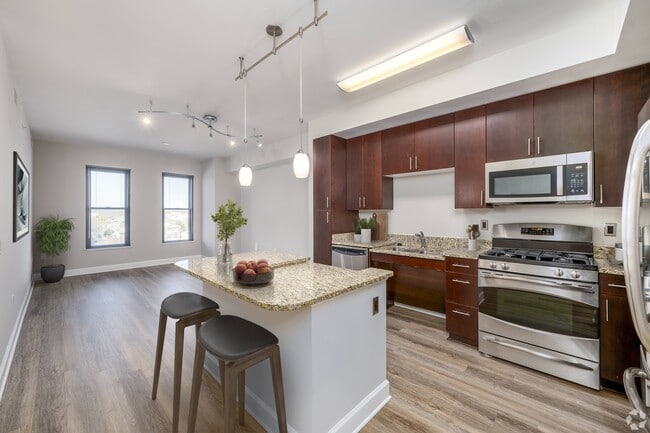 Kitchen with LTV flooring (virtually staged) - Park Place at Petworth Apartments