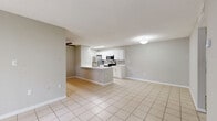 Located in Palm Harbor, FL, this single-story, one-bedroom, one-bathroom home offers a functional and well-organized layout finished consistently in light ceramic tile flooring throughout. The open-concept living and dining area provides a bright, airy atmosphere with neutral gray walls and clean white baseboards, creating a versatile space adaptable to various furniture arrangements. The kitchen is a standout feature, equipped with stainless steel appliances including a refrigerator, electric range, and over-the-range microwave. White shaker-style cabinetry with modern hardware pairs with white countertops and a classic subway tile backsplash, delivering a clean, contemporary aesthetic. A peninsula counter adds additional prep and seating space. A dedicated pantry provides additional storage. The bedroom is comfortably sized and benefits from a natural light source via a window overlooking greenery, along with access to two closets. The bathroom is finished in a crisp, all-white palette featuring a tub-shower combination, a single-vanity with white cabinetry, and tile flooring. A private patio extends the living space outdoors, ideal for relaxation. The home also includes in-unit laundry access.