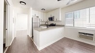 Located at 833 S Berendo St in Los Angeles, this one-bedroom, one-bathroom unit offers a efficiently designed single-floor layout with modern updates throughout. The open-concept kitchen serves as a central feature of the living space, showcasing white shaker cabinetry extending to the ceiling, quartz countertops, and a peninsula with an undermount sink. Stainless steel appliances — including a gas range, over-the-range microwave, and refrigerator — complete the kitchen. A window above the counter provides natural light, enhancing the clean, bright aesthetic.

Wood-style laminate flooring runs throughout the main living areas, contributing to a cohesive and contemporary feel. The bedroom is a well-proportioned space featuring a window with blinds for natural light and a full wall of mirrored sliding closet doors that visually expand the room. A textured ceiling is consistent throughout the unit.

The bathroom is efficiently laid out with white cabinetry, a tub-shower combination, and dark tile flooring that contrasts cleanly with the white walls and fixtures. The unit is located in the Koreatown neighborhood, offering convenient access to dining, transit, and local amenities.