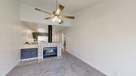 Located at 1525 Bridge St in Yuba City, California, this single-floor, 2-bedroom, 3-bathroom home offers a practical and comfortable layout across a well-organized floor plan. The welcoming entrance leads into a bright, open living area anchored by a standout tile-surround fireplace with a bold black cylindrical flue — a defining architectural feature that separates the living room from the kitchen. Ceiling fans are present throughout, enhancing comfort and airflow. The kitchen is functional and stylish, featuring gray cabinetry, white countertops, light wood-style flooring, and black appliances including a range, microwave, and dishwasher, alongside a full-size refrigerator. A pass-through connects the kitchen to the adjacent dining and living areas, creating an open, connected feel. The bedrooms are carpeted and bright, with natural light provided by windows fitted with blinds. The primary bedroom benefits from a ceiling fan and a sliding glass door opening to a private balcony. The three bathrooms are clean and well-appointed, offering a mix of tub/shower combos and glass-enclosed showers. Additional features include a dedicated laundry area, four closets for ample storage, and a hallway connecting the rooms cohesively throughout the home.