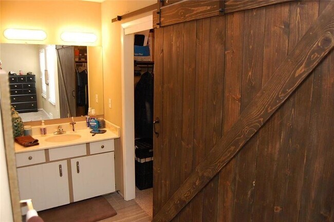 Interior barn door added to walk-in closet in master. - 8610 W. 109th St,