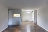 Located at 1543 Ambergrove Dr in San Jose, CA, this single-floor residence offers 2 bedrooms and 3 bathrooms with a functional, well-organized layout. The open living and dining area features rich, dark hardwood-style flooring and a textured ceiling, with natural light streaming in through a sliding glass door that leads directly to a private patio. A pass-through window connects the living area to the kitchen, enhancing the sense of openness. The galley-style kitchen is outfitted with white cabinetry, glass-front upper cabinets, light wood-tone flooring, and stainless steel appliances including a range and refrigerator, complemented by a built-in dishwasher and a double sink with ample counter space. Both bedrooms are carpeted and feature vertical blinds over windows that bring in natural light, with the generously sized primary bedroom offering a dedicated closet. The three bathrooms are clean and bright, each featuring wood-tone flooring and a shower-tub combination. Additional highlights include multiple closets throughout, a laundry area, a utility room, and baseboard heating. The layout is efficient and practical, making excellent use of every square foot.