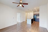 This 660 square foot apartment in Houston, TX offers a thoughtful blend of comfort and functionality. The single-bedroom layout is complemented by two full bathrooms, enhancing convenience for residents and guests alike. The open-concept design seamlessly integrates the kitchen and living areas, maximizing the use of space.

The kitchen is a highlight, featuring rich dark wood cabinetry, sleek black appliances, and elegant granite countertops. A central island with a sink serves as both a prep area and casual dining spot. The living room flows naturally from the kitchen, with plush carpeting for comfort and large windows that flood the space with natural light.

The bedroom, measuring 140 square feet, offers ample space and is adorned with plush carpeting and ceiling fan for comfort. The bathrooms are well-appointed with modern fixtures, including a combination tub-shower in at least one.

Throughout the apartment, you'll find a mix of warm wood-look flooring and soft carpeting. Ceiling fans in main living areas provide air circulation and comfort. The balcony, accessible through French doors with built-in blinds, extends the living space outdoors.

This apartment combines modern amenities with a practical layout, creating an inviting home in the heart of Houston.
