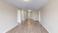 Located at 1020 Paisley Rd in Guelph, Ontario, this thoughtfully designed 2-bedroom, 2-bathroom residence offers a comfortable and functional layout across a single floor. The open-concept kitchen and living area serves as the heart of the home, featuring a well-equipped kitchen with white shaker-style cabinetry, grey laminate countertops, stainless steel appliances including a refrigerator, electric range, built-in microwave, and dishwasher, all set over light-toned flooring. The spacious living area is finished with warm hardwood-style laminate floors and neutral beige walls, with sliding glass doors that open onto a private balcony overlooking the surrounding neighbourhood. The generously sized primary bedroom includes a dedicated walk-in closet outfitted with wire shelving and hanging rods for ample storage. The second bedroom also benefits from a large window with neighbourhood views and matching laminate flooring. Two full bathrooms complete the layout: one features a walk-in shower with grab bars, while the second includes a full tub-shower combination and a vanity with a marble-style countertop. Throughout the residence, clean lines, bright neutral tones, and practical finishes create a modern and welcoming atmosphere.