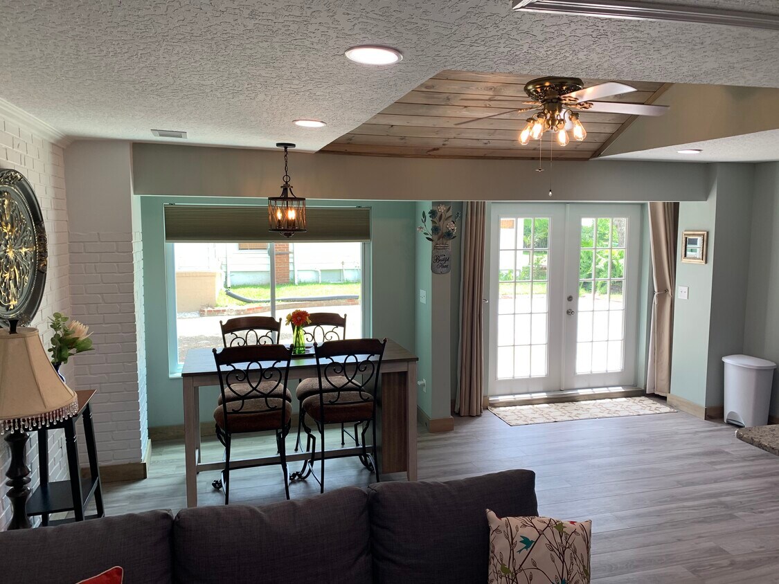 Living to Dining Room and lots of natural light with curtains and shades for privacy. - 105 E Melbourne Ave