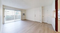 Located at 1560 S Highland Ave in Fullerton, CA, this single-story 2-bedroom, 3-bathroom residence offers a clean, modern aesthetic throughout. Light wood-style flooring runs continuously across the living spaces, complementing the bright white walls and creating a cohesive, airy feel.

The open living and dining area is a welcoming centerpiece, featuring large sliding glass doors with vertical blinds that flood the room with natural light and provide direct access to a private patio. The galley-style kitchen is well-appointed with white shaker cabinetry extending to the ceiling, a stainless steel sink with a modern pull-down faucet, a dishwasher, gas range, microwave, and refrigerator, all set against light countertops and recessed lighting.

Both bedrooms are generously proportioned with large windows that invite natural light. The primary bedroom includes direct access to a private bathroom and a walk-in closet with built-in shelving. A second walk-in style closet and additional closets provide ample storage throughout. The bathrooms are finished in a clean, neutral palette featuring white vanities, light countertops, and tub-shower combinations with brushed nickel hardware. A hallway and dedicated pantry round out this thoughtfully laid-out home.