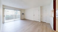 Located at 1560 S Highland Ave in Fullerton, CA, this single-story 2-bedroom, 3-bathroom residence offers a clean, modern aesthetic throughout. Light wood-style flooring runs continuously across the living spaces, complementing the bright white walls and creating a cohesive, airy feel.

The open living and dining area is a welcoming centerpiece, featuring large sliding glass doors with vertical blinds that flood the room with natural light and provide direct access to a private patio. The galley-style kitchen is well-appointed with white shaker cabinetry extending to the ceiling, a stainless steel sink with a modern pull-down faucet, a dishwasher, gas range, microwave, and refrigerator, all set against light countertops and recessed lighting.

Both bedrooms are generously proportioned with large windows that invite natural light. The primary bedroom includes direct access to a private bathroom and a walk-in closet with built-in shelving. A second walk-in style closet and additional closets provide ample storage throughout. The bathrooms are finished in a clean, neutral palette featuring white vanities, light countertops, and tub-shower combinations with brushed nickel hardware. A hallway and dedicated pantry round out this thoughtfully laid-out home.