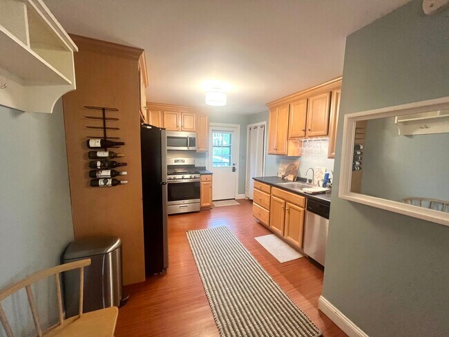 Kitchen with stainless steel appliances, opens up to a dining/living room combo - 23 County St