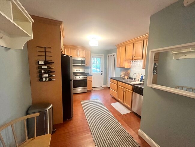 Kitchen with stainless steel appliances, opens up to a dining/living room combo - 23 County St