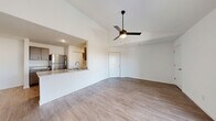 Located at 3555 Sirocco Way in Lafayette, Indiana, this single-floor, 3-bedroom, 2-bathroom home offers a well-designed open-concept layout. The combined living and kitchen area is anchored by vaulted ceilings and a sleek ceiling fan, creating an airy, spacious feel. Light wood-style flooring flows throughout the main living areas, complementing the bright, neutral color palette. Sliding glass doors open to a private balcony, filling the living room with natural light and outdoor views.

The kitchen features taupe cabinetry, granite-style countertops, stainless steel appliances, and a pass-through counter that connects seamlessly to the living area. The primary bedroom is generously sized, also with sliding balcony access, a ceiling fan, and wood-style flooring. It includes a large walk-in closet with wire shelving systems offering ample storage. Additional bedrooms are carpeted and each include ceiling fans and closets. The bathrooms are clean and functional, with one featuring a full soaking tub and shower combination with wood-style flooring. The home also includes a spacious walk-in closet with multi-level wire shelving, providing exceptional storage capacity throughout.