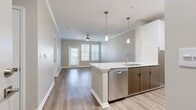 This contemporary 690 square foot apartment in Charleston, SC offers a thoughtful blend of style and functionality. The single-floor layout maximizes space efficiency, featuring one bedroom and two full bathrooms. The heart of the home is an open-concept living area, seamlessly connecting the kitchen and living room. The kitchen boasts white cabinetry, stainless steel appliances, and a practical breakfast bar, ideal for casual dining or entertaining.

The spacious primary bedroom, measuring 220 square feet, provides ample room for relaxation and includes a closet for storage. Both bathrooms feature modern fixtures and neutral tiled flooring. Throughout the apartment, wood-look flooring adds warmth and durability to the living spaces, while plush carpeting in the bedroom ensures comfort underfoot.

Large windows with white blinds allow for abundant natural light, complementing the apartment's light, neutral color palette. Ceiling fans in the main living area and bedroom provide air circulation and add a decorative touch. The unit also includes a dedicated closet space for additional storage needs.

Located at 480 Seven Farms Drive in Building 901, Unit 211, this apartment combines modern amenities with a prime Charleston location, offering a perfect balance of comfort and convenience for urban living.