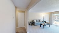 Located at 1900 Stevens Dr in Richland, WA, this 1-bedroom, 1-bathroom unit is thoughtfully laid out across a single floor, offering a comfortable and efficient use of space. The living room serves as the central gathering area, featuring warm neutral-toned walls, plush carpeted flooring, a textured ceiling, and a sliding glass door with vertical blinds that opens to a private outdoor balcony, allowing natural light to fill the room. Adjacent to the living area, the kitchen is equipped with white appliances, warm wood-toned cabinetry, and tile flooring, providing a functional cooking space. A connecting hallway links the main living areas to the private quarters. The bedroom is a cozy retreat, featuring generous closet space with wide sliding and hinged doors, soft carpeted floors, a large window with vertical blinds for natural light, and a textured ceiling that carries through from the rest of the unit. The full bathroom is clean and practical, outfitted with tile flooring, a tub-shower combination, a white vanity with sink, and neutral warm-toned walls. Throughout the unit, a consistent warm beige color palette and soft carpeting create a cohesive and inviting ambiance.