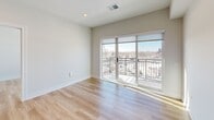 Located at 4 N Hickory Ave in Arlington Heights, IL, this thoughtfully designed 2-bedroom, 2-bathroom residence offers a modern aesthetic throughout its well-appointed single-floor layout. Light-toned hardwood flooring flows seamlessly across the entire space, complementing the clean white walls and recessed lighting that create a bright, airy atmosphere.

The open-concept kitchen, dining, and living area serves as the heart of the home. The kitchen features a sleek island with a white quartz countertop, an undermount stainless steel sink, and matte black fixtures. Dark lower cabinetry contrasts beautifully with natural wood upper cabinets, while stainless steel appliances — including a gas range, microwave, and full-size refrigerator — complete the space. A striking industrial-style pendant light fixture anchors the kitchen island.

The combined living and dining area is bathed in natural light from large sliding glass doors that open onto a private balcony, offering views of the Arlington Heights skyline. Both bedrooms are generously sized, with large windows that frame outdoor views. The primary bedroom benefits from abundant natural light and direct balcony access. Four closets provide ample storage throughout. The two bathrooms feature clean, neutral finishes, with one including a full soaking tub. An in-unit laundry area adds everyday convenience.