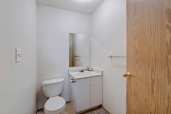 A half bath with toilet and sink - Carrington Place