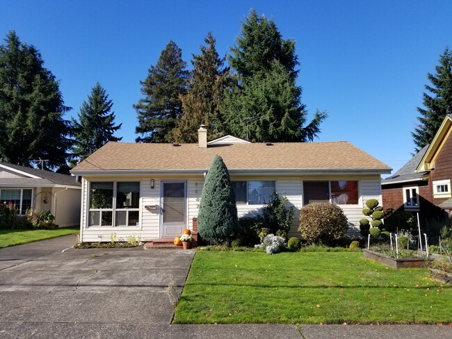 Front exterior with gardens - 8607 N Exeter Ave