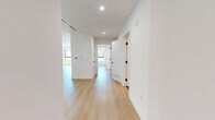 Located at 350 North Palm Drive in the heart of Beverly Hills, this thoughtfully designed 2-bedroom, 2-bathroom residence offers a refined modern aesthetic throughout. Light wide-plank hardwood flooring flows seamlessly across the entire floor plan, complementing the crisp white walls and recessed lighting that define each room.

The open-concept living area is anchored by expansive floor-to-ceiling windows with black-framed detailing, flooding the space with natural light and offering views of the surrounding tree-lined neighborhood. A private balcony extends the living area outdoors. The chef's kitchen features flat-front light wood cabinetry, a dramatic marble slab backsplash, sleek white quartz countertops, an integrated stainless steel sink, and high-end built-in appliances including a professional range hood and double wall ovens.

Both bedrooms are generously proportioned with large picture windows framing green canopy views. The primary bedroom includes a dedicated walk-in closet outfitted with custom built-in shelving, hanging rods, and drawer units. The primary bathroom is spa-inspired, showcasing a freestanding soaking tub, glass-enclosed shower, stone tile flooring, and a floating wood vanity. The second bathroom features large-format dark tile floors, a floating vanity with charcoal countertop, and elegant pendant lighting.