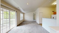 Located at 9123 Cleveland St in Merrillville, Indiana, this single-floor, one-bedroom, one-bathroom unit offers a thoughtfully organized layout with a complete set of functional spaces. The living area is bright and welcoming, featuring soft wall-to-wall carpeting, neutral cream-toned walls, and generous natural light streaming through large windows with outdoor views of mature trees. Glass sliding doors provide additional light and a connection to the outdoors. The kitchen is well-equipped with warm honey-toned wood cabinetry, granite-look countertops, wood-look vinyl plank flooring, and white appliances including a gas range, microwave, refrigerator, and dishwasher — offering ample counter and storage space. The bedroom is comfortably sized with plush carpeting, a bright window, and notably tall ceilings that enhance the sense of openness. It connects directly to a walk-in closet outfitted with wire shelving and hanging rods, providing excellent storage capacity. The bathroom features a full soaking tub and shower combination with a clean white surround, complemented by wood-look tile flooring. A dedicated laundry area houses a full-size side-by-side washer and dryer, adding everyday convenience. The overall ambiance is clean, neutral, and move-in ready.