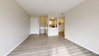 Located in Parkville, Missouri, this 2-bedroom, 1-bathroom residence offers a well-organized, single-floor layout accessed via a carpeted staircase that leads to the main living space. The open living room is bright and airy, featuring light luxury vinyl plank flooring and a sliding glass door that opens onto a private balcony with outdoor views, allowing ample natural light to fill the space. The kitchen is positioned adjacent to the living area and is equipped with white cabinetry, granite-style countertops, a gas range, dishwasher, and a window above the sink. A dedicated laundry area and utility room add everyday convenience. Both bedrooms are carpeted and include ceiling fans and closets — one bedroom features a walk-in closet, while the other offers a standard closet. Each bedroom is fitted with window blinds that provide natural light and privacy. The shared full bathroom includes a tub-shower combination, a window with blinds, and granite-style countertops. With four closets throughout, the layout maximizes storage. The neutral color palette and clean finishes throughout create a cohesive and functional living environment.