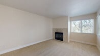 This single-floor, 2-bedroom, 2-bathroom home in Meridian offers a thoughtfully designed layout with a blend of carpet and hardwood-style flooring throughout. The carpeted living room serves as a welcoming focal point, centered around a tile-surround fireplace and framed by windows that fill the space with natural light. Adjacent, the galley-style kitchen is outfitted with dark espresso cabinetry, white countertops, stainless steel appliances including a refrigerator, dishwasher, microwave, and range, and warm hardwood-style flooring — all opening to a combined dining area. Both bedrooms are generously proportioned with plush carpet, large windows overlooking lush greenery, and dedicated closets. The primary bedroom benefits from added convenience with direct access to its own bathroom. Each bathroom features a full tub-shower combination, rich wood-toned vanity cabinetry, white countertops, and hardwood-style flooring. An in-unit laundry area adds everyday practicality. The private patio is a standout feature, offering a serene, tree-canopied retreat with a wood deck and open railing — ideal for enjoying the natural surroundings. Three closets provide ample storage throughout the home.