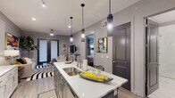 Located in Little Rock, AR, this single-floor residence on S Bowman Road showcases a contemporary design with a cohesive gray-toned palette, light wood-look flooring, and carefully curated finishes throughout. The open-concept kitchen serves as the heart of the home, featuring white shaker cabinetry, quartz countertops, a large center island with a stainless steel sink and pendant lighting overhead, and stainless steel appliances including a range, microwave, and refrigerator. The kitchen flows seamlessly into the living area, which is brightened by natural light from glass-paneled entry doors. The bedroom offers a serene retreat with plush carpet, ample natural light from well-dressed windows, and refined architectural details. The bathroom is finished to a high standard, with floor-to-ceiling marble-look tile, a spacious frameless glass walk-in shower equipped with a built-in niche, and polished chrome fixtures. Recessed lighting and stylish pendant fixtures illuminate the space throughout, while the neutral gray walls and modern interior doors with dark hardware provide a consistent, polished aesthetic. The overall ambiance is sleek, contemporary, and thoughtfully designed for comfortable everyday living.